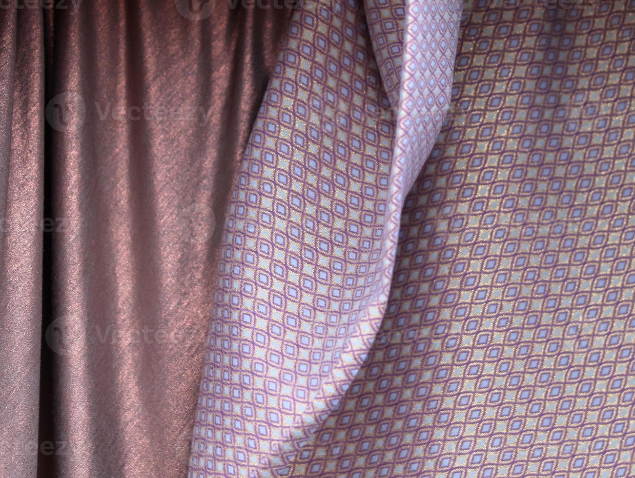 Detailed close up view on samples of cloth and fabrics in different colors found at a fabrics market photo