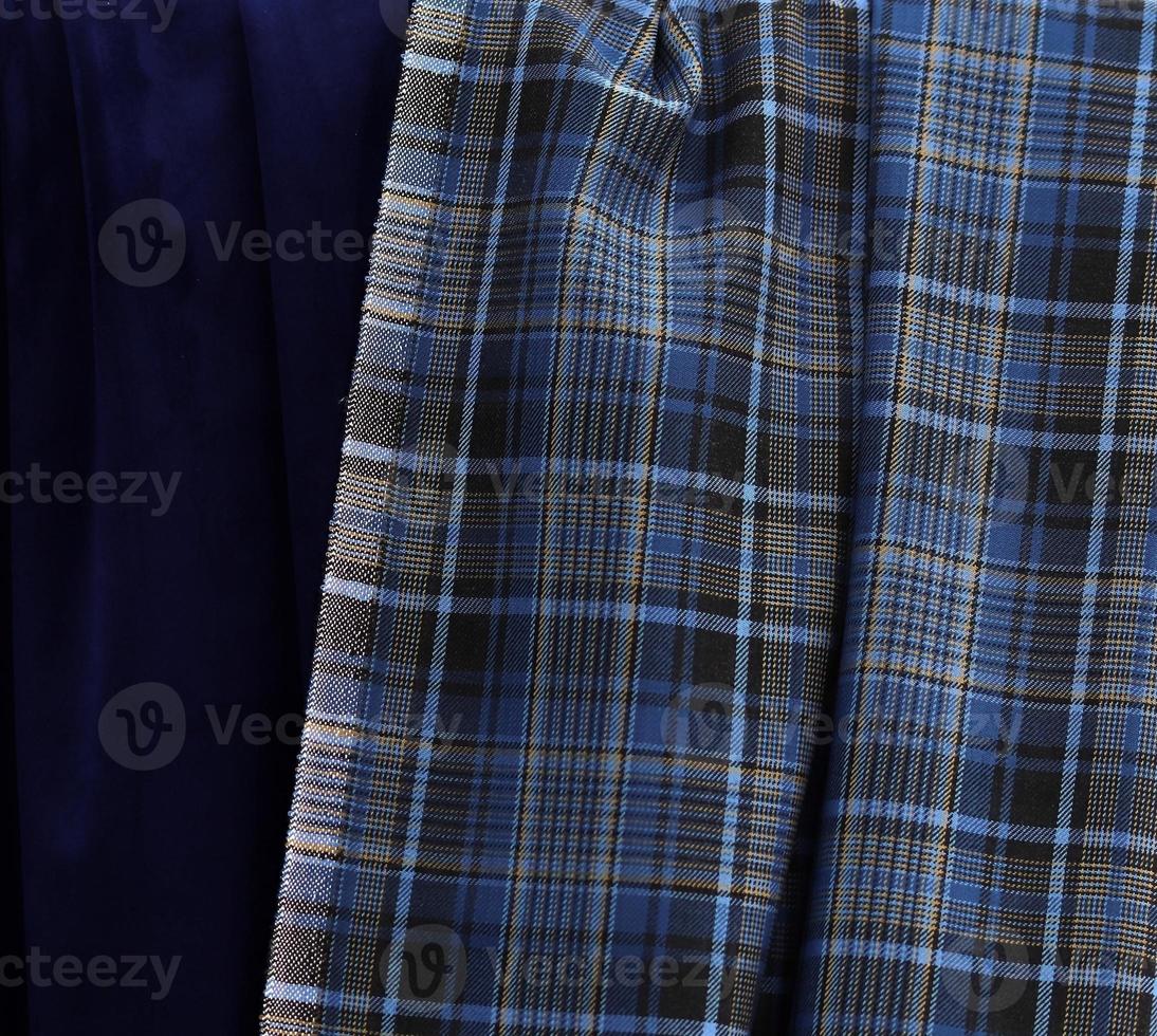 Detailed close up view on samples of cloth and fabrics in different colors found at a fabrics market photo