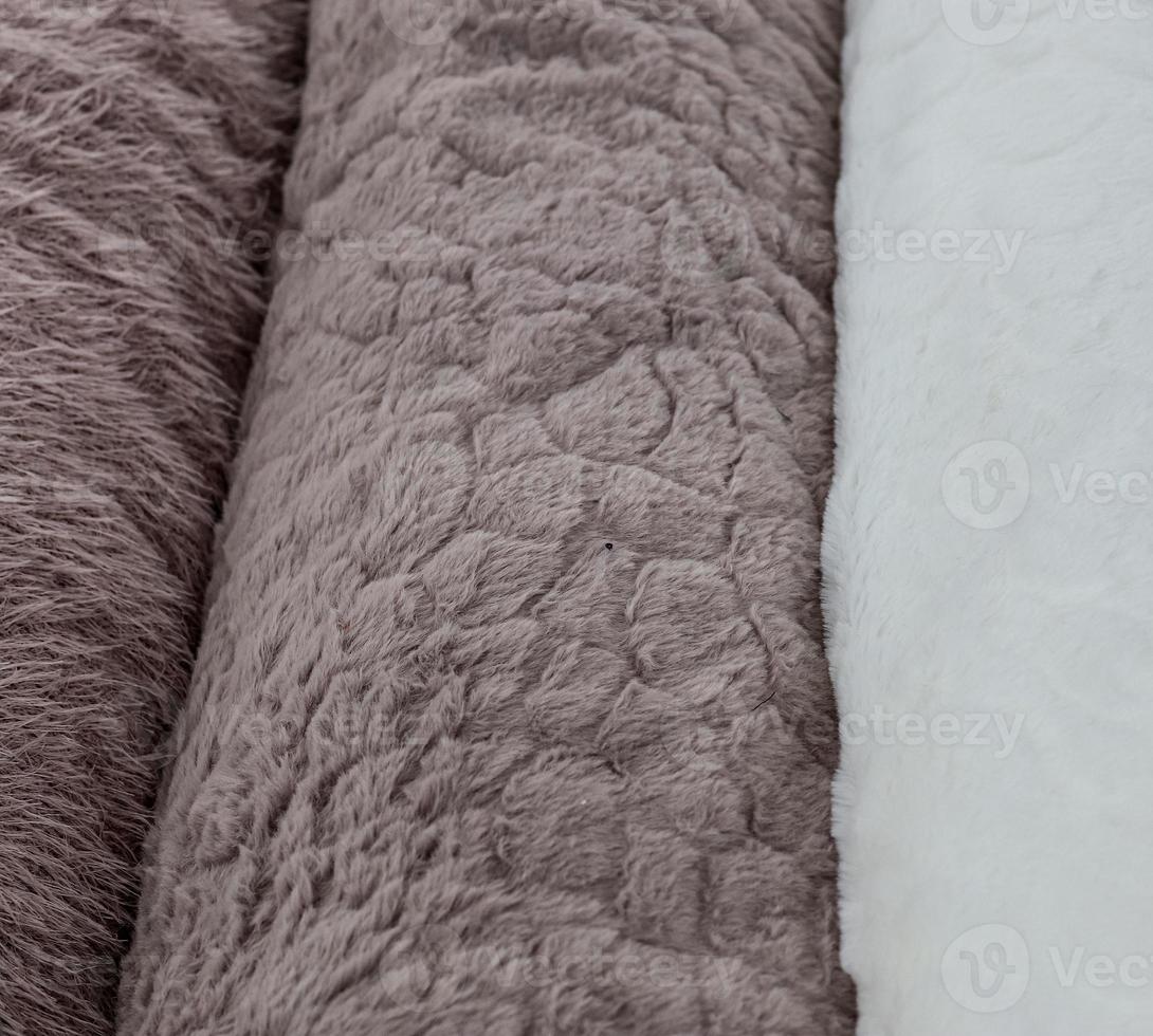 Detailed close up view on samples of cloth and fabrics in different colors found at a fabrics market photo