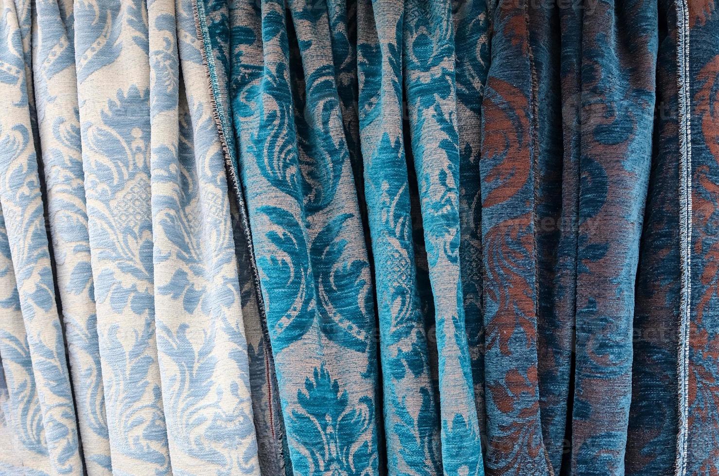 Detailed close up view on samples of cloth and fabrics in different colors found at a fabrics market photo
