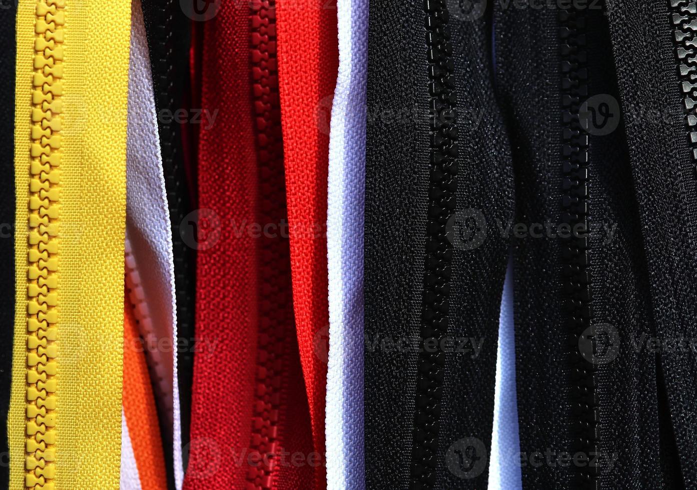 Detailed close up view on samples of cloth and fabrics in different colors found at a fabrics market photo