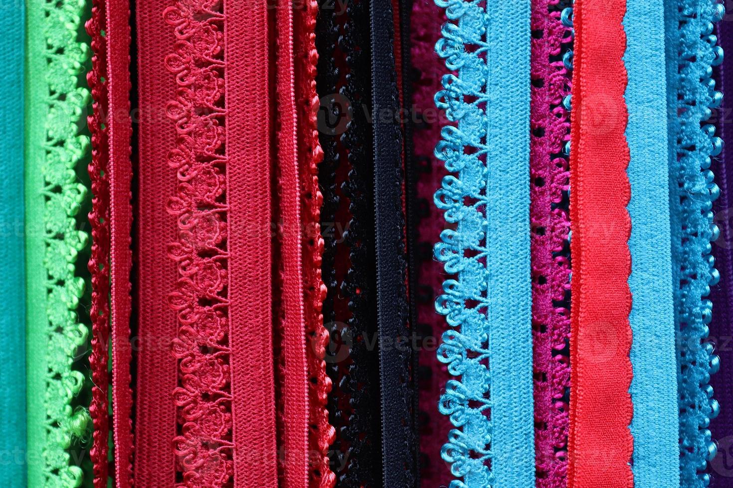 Detailed close up view on samples of cloth and fabrics in different colors found at a fabrics market photo