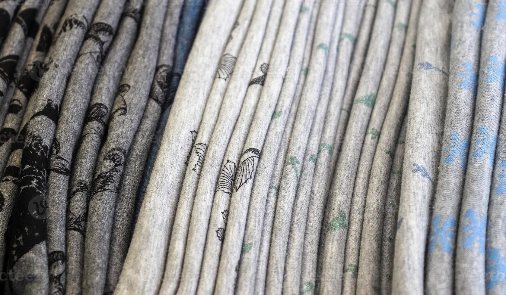 Detailed close up view on samples of cloth and fabrics in different colors found at a fabrics market photo