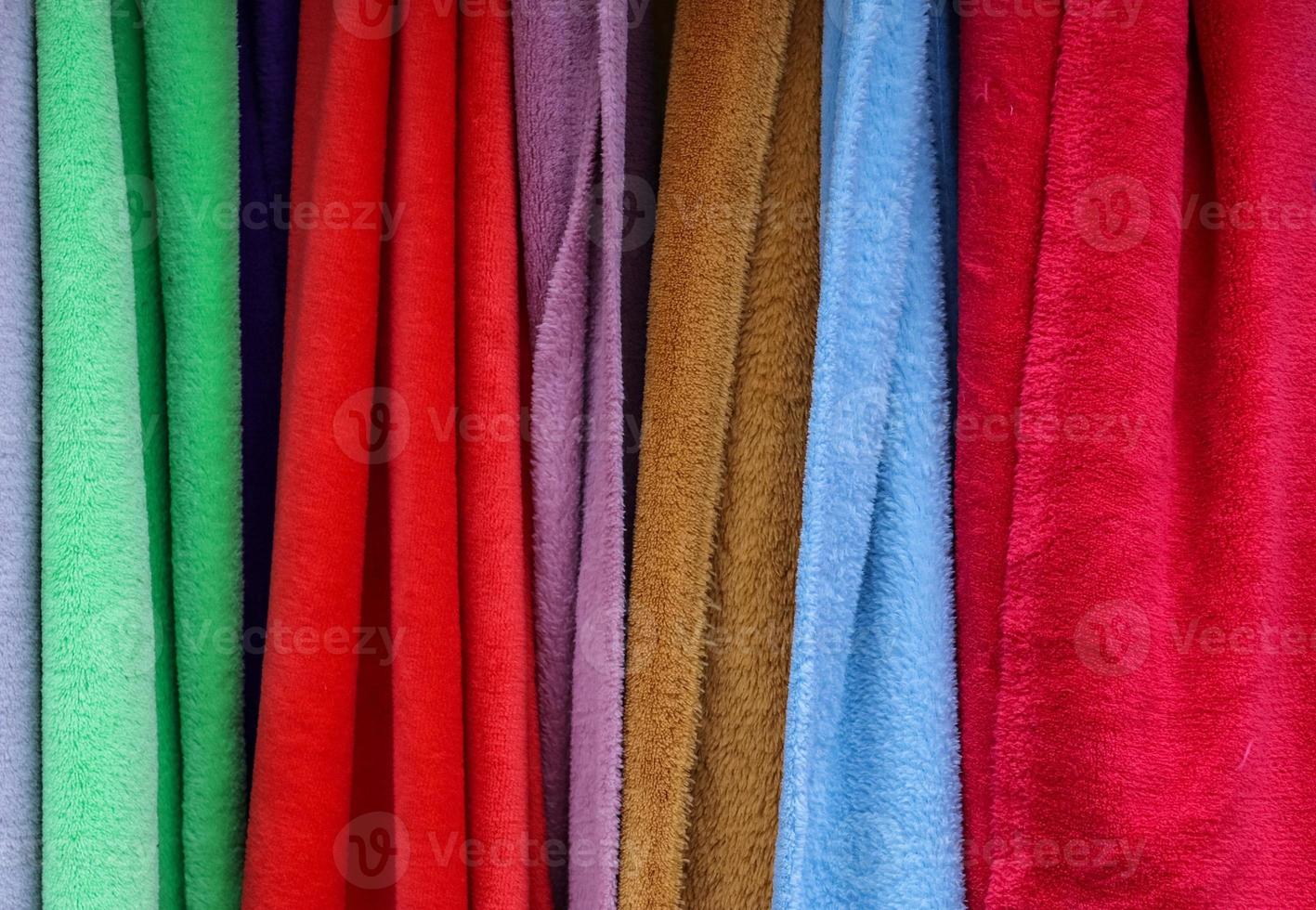 Detailed close up view on samples of cloth and fabrics in different colors found at a fabrics market photo