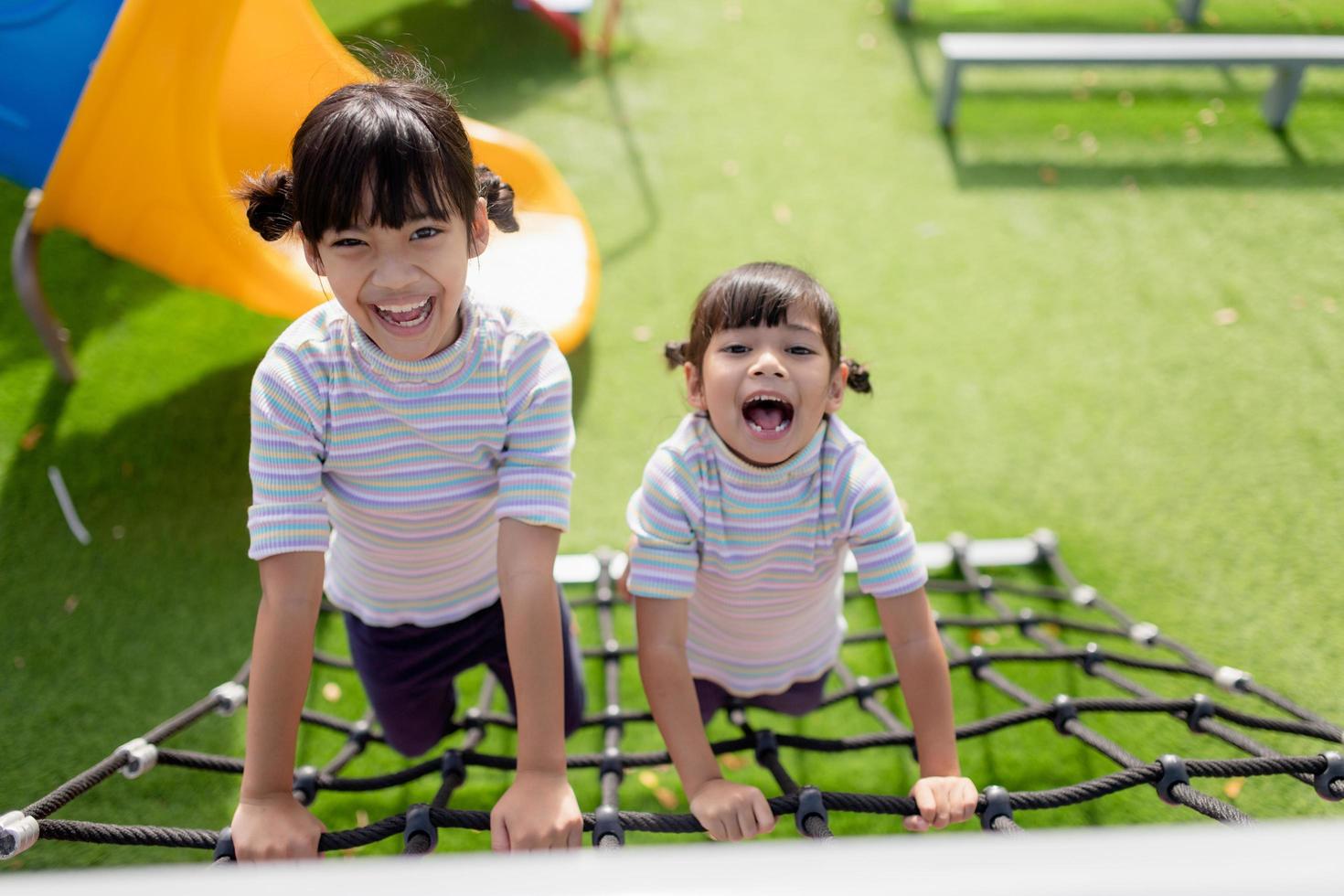 Little school kids climbing in the school playground. photo