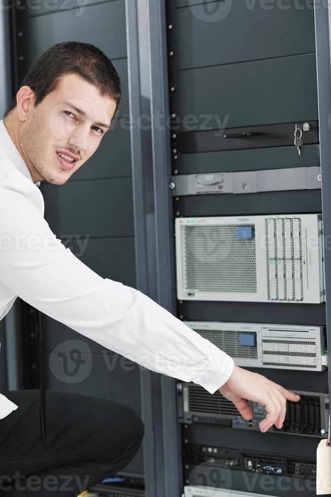 young it engeneer in datacenter server room photo