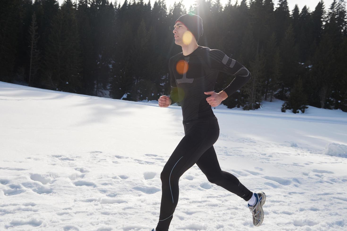 jogging on snow in forest photo
