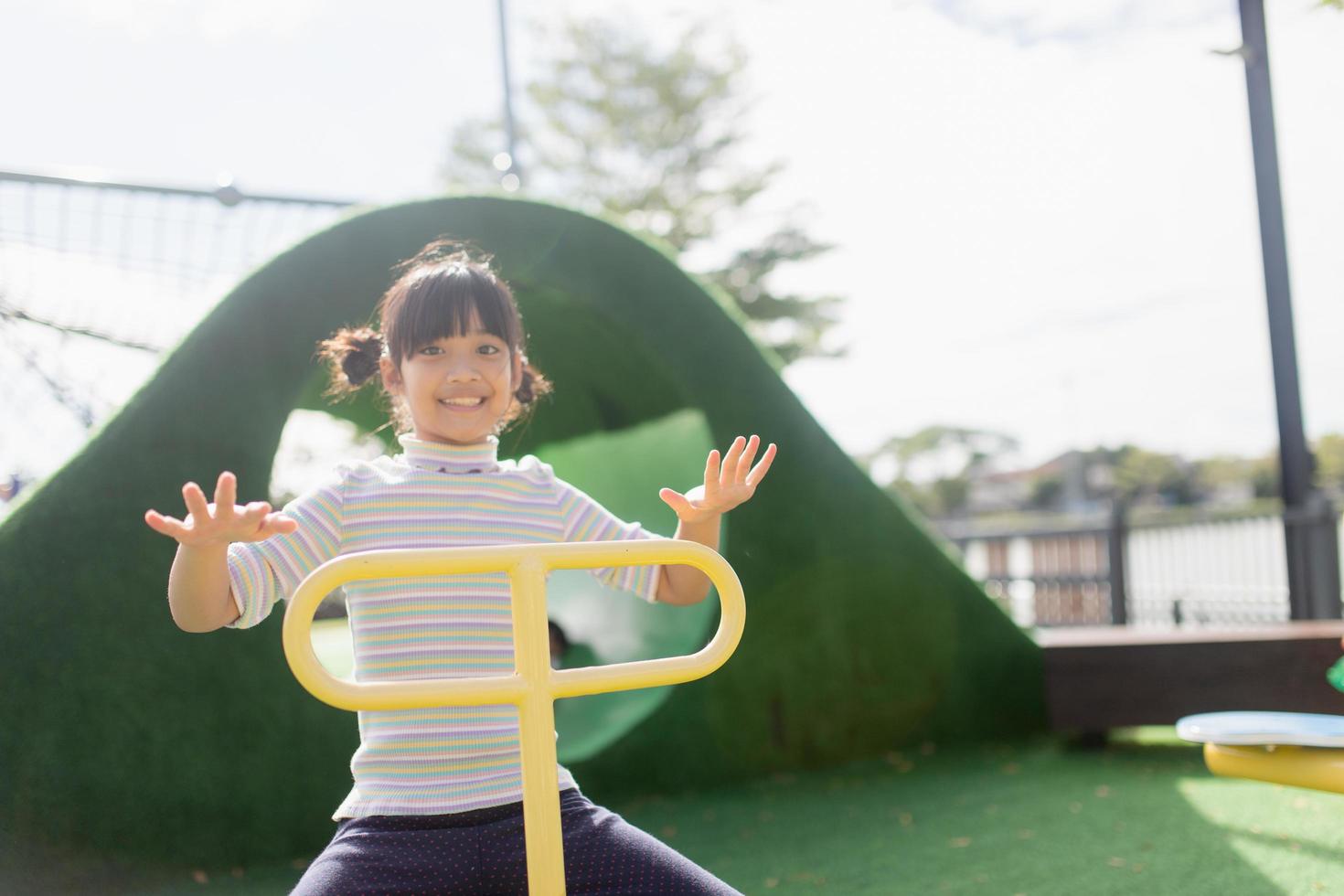 Kids playing at the see-saw in the playground photo