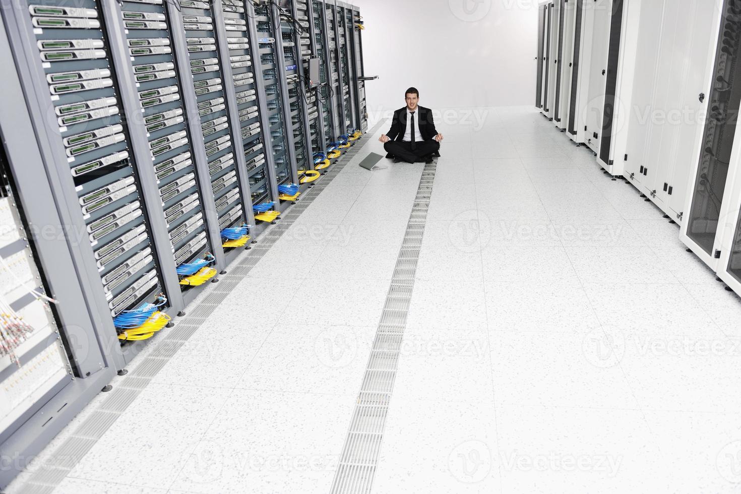 business man practice yoga at network server room photo