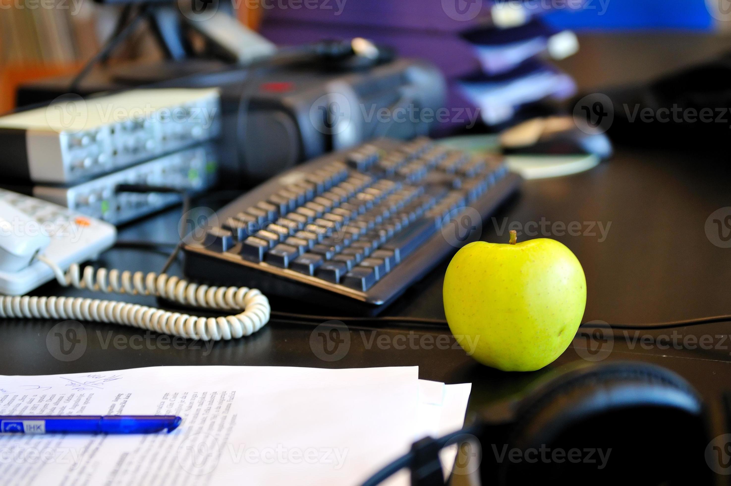 Apple on desk 11579860 Stock Photo at Vecteezy