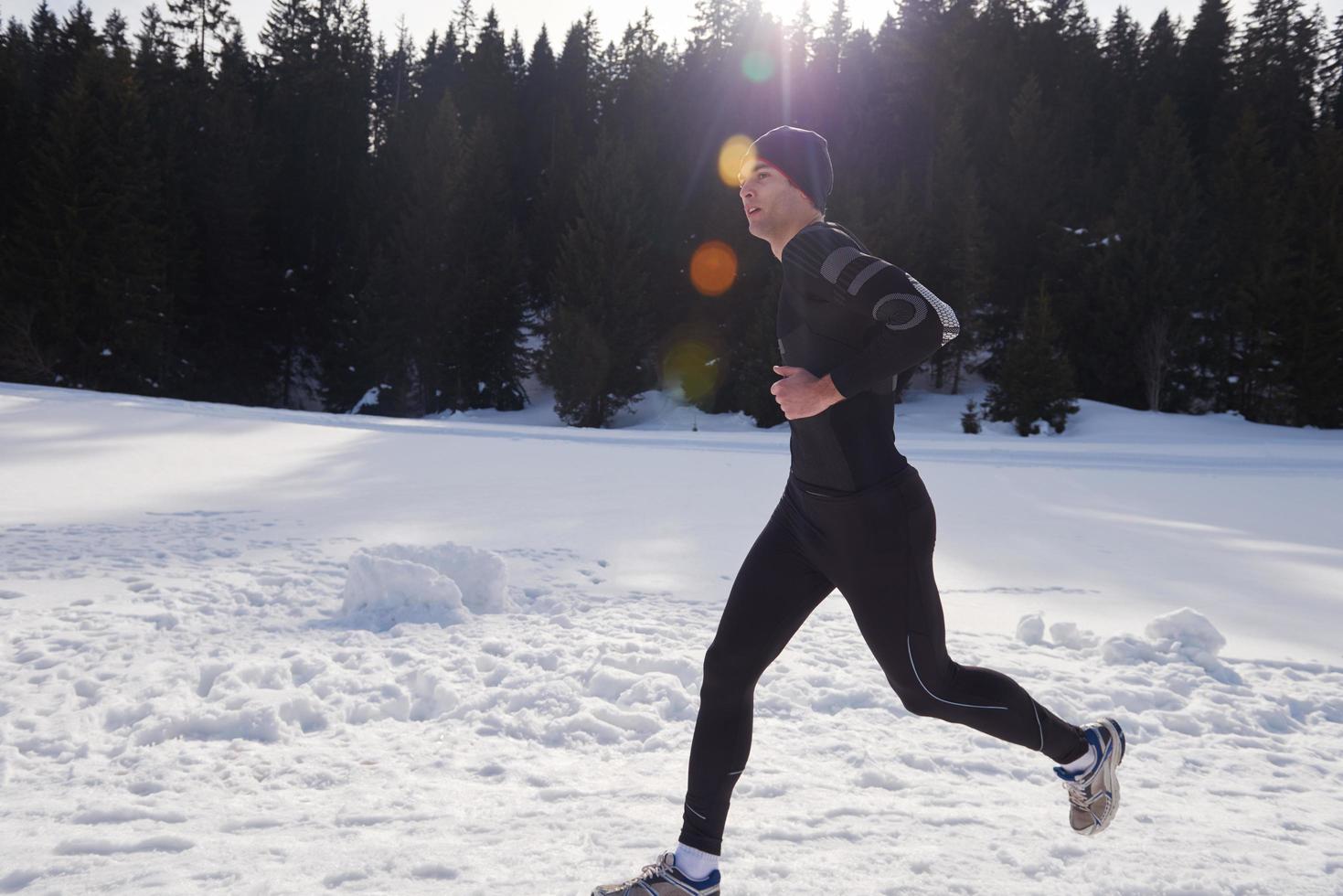 jogging on snow in forest photo