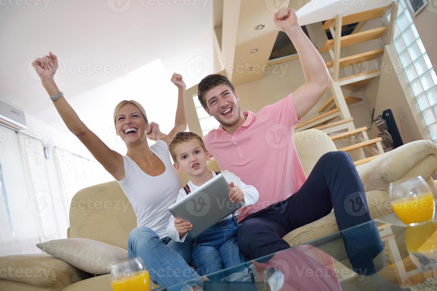 family at home using tablet computer photo
