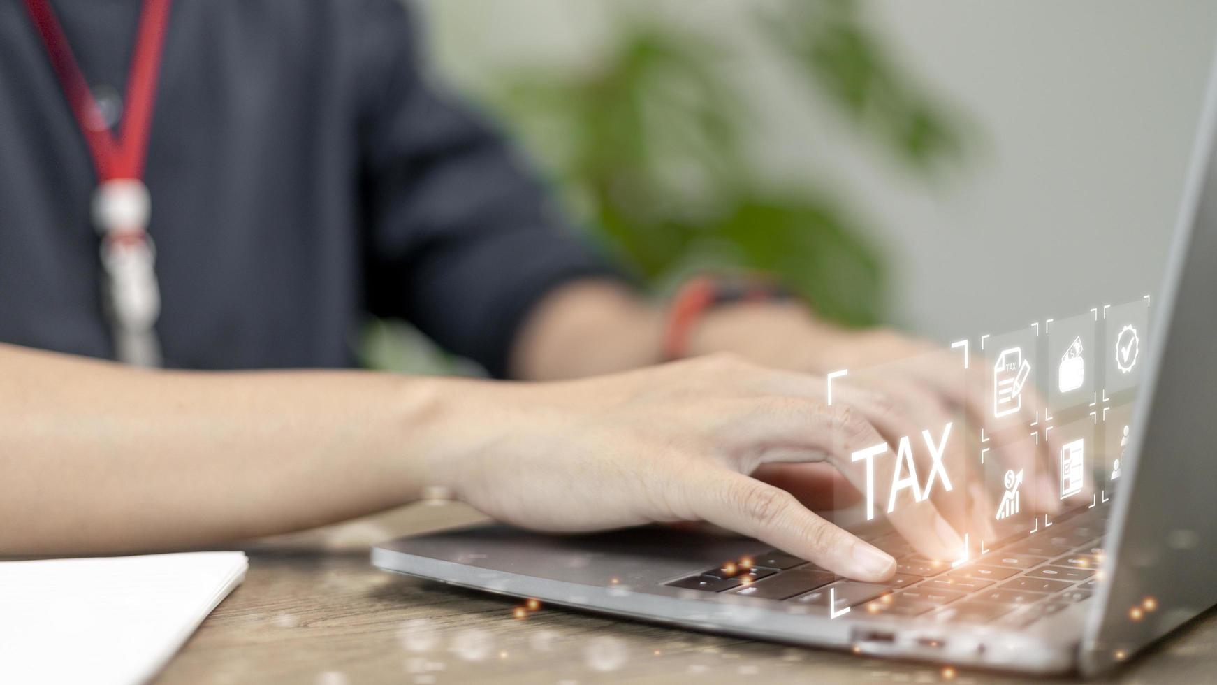 Businesswoman use a computer to complete Individual income tax return forms online for tax payment. Government, state taxes. Data analysis, financial research, report. Calculation of tax return. photo
