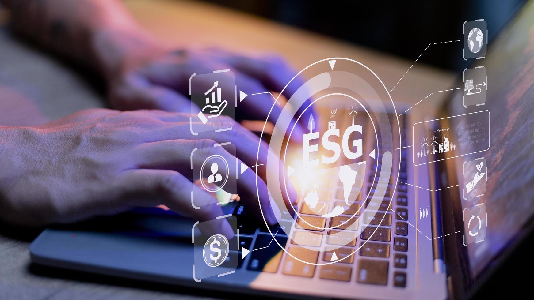 Businessman using a computer for analysis ESG environmental social governance business strategy investing concept. photo