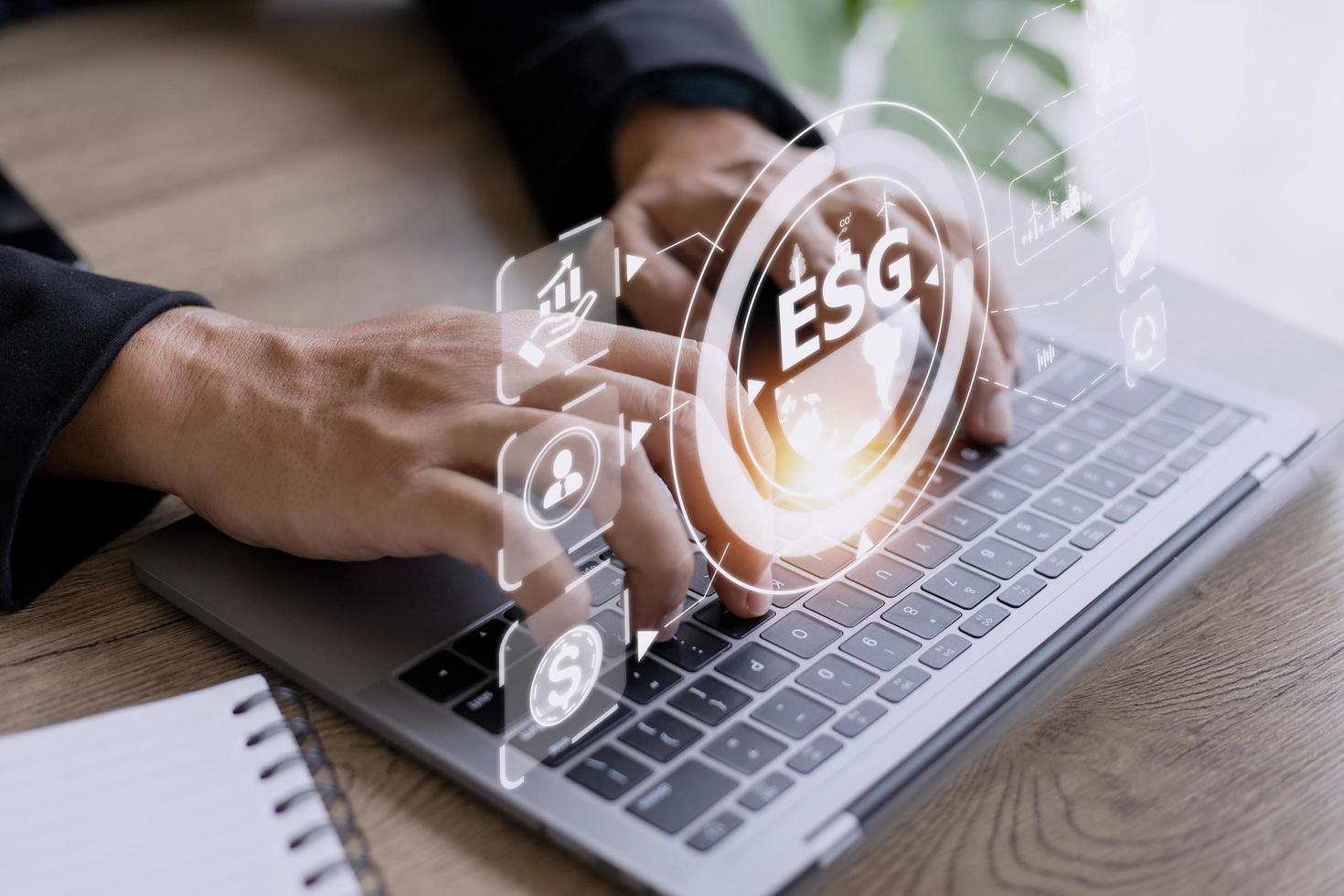 Businessman using a computer for analysis ESG environmental social governance business strategy investing concept. photo