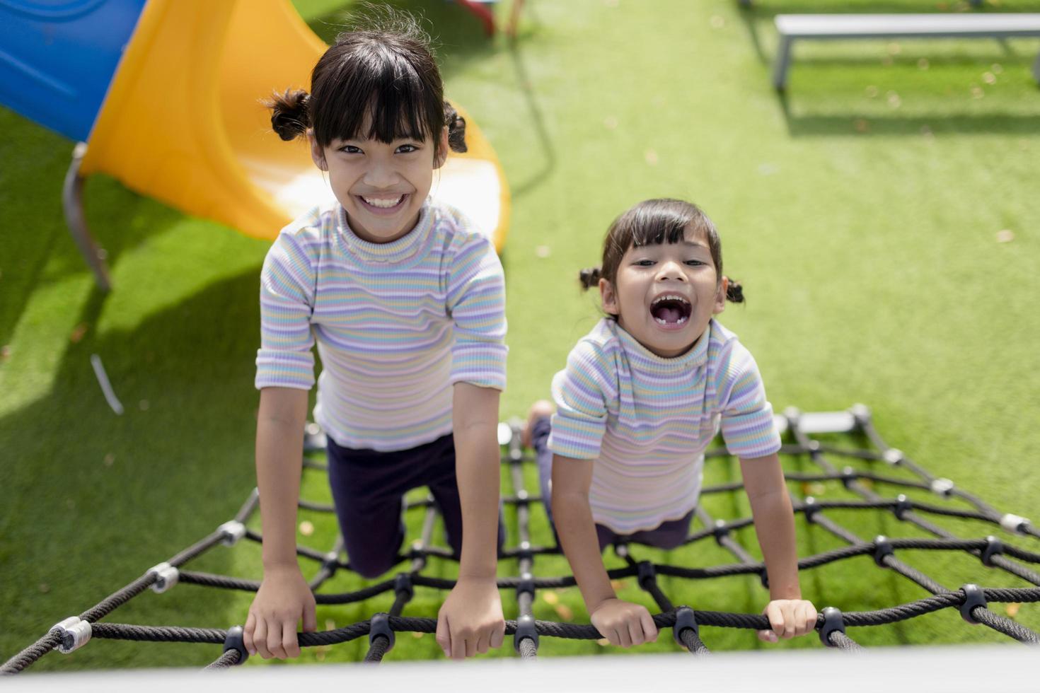 Little school kids climbing in the school playground. photo