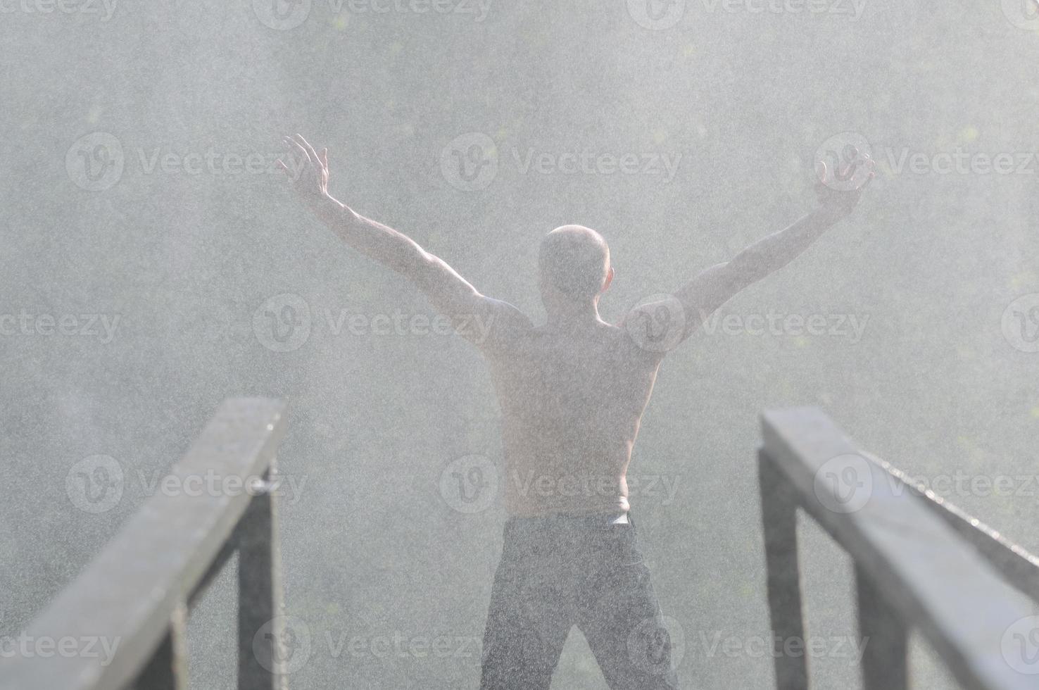 Man in waterfall photo