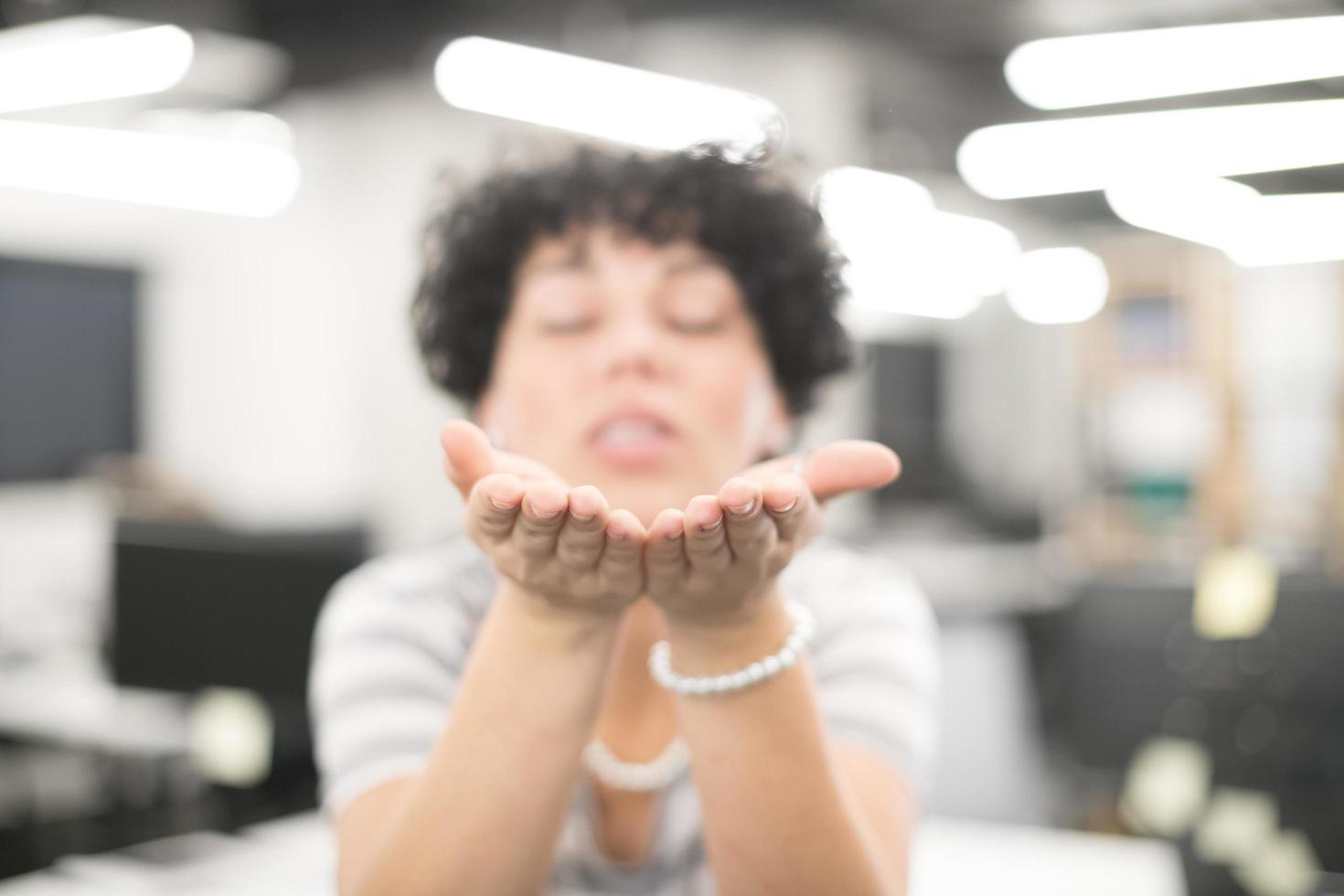 Woman blowing hands photo