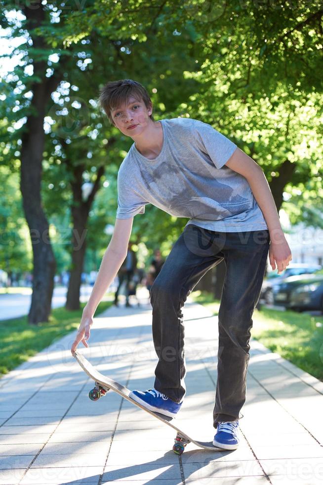 Skateboard jumping on sidewalk photo