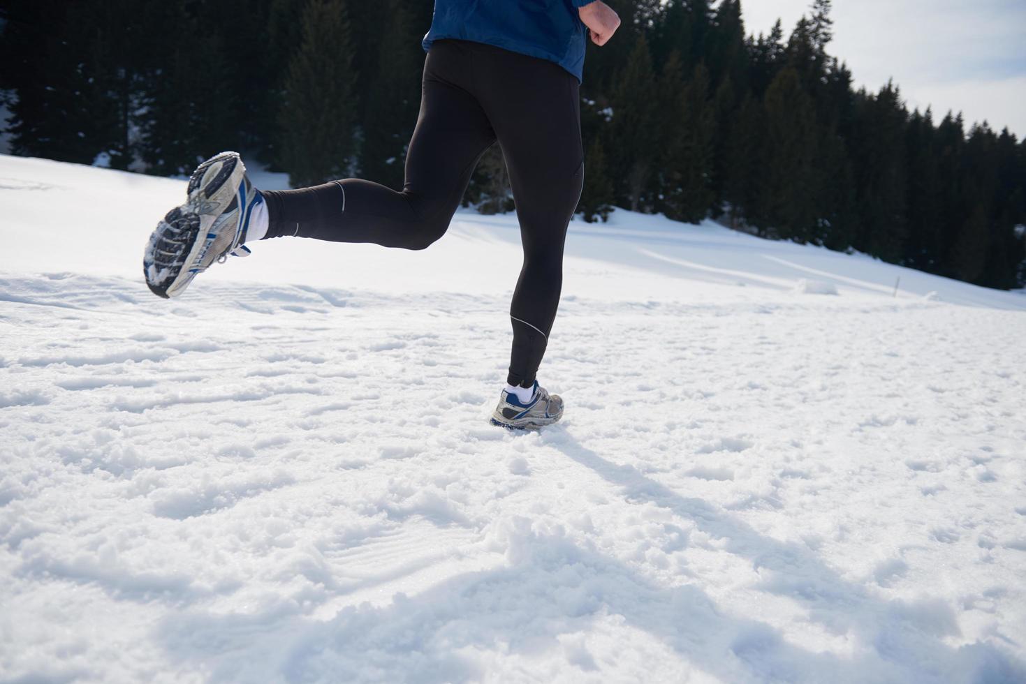 jogging on snow in forest photo