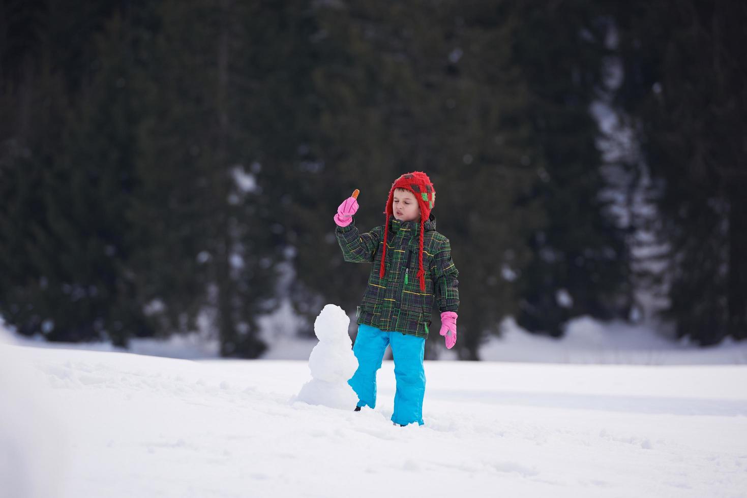 boy making snowman photo