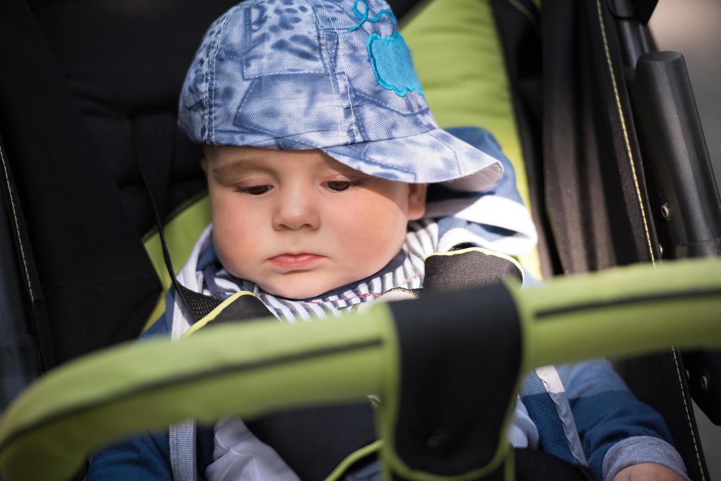 baby boy sitting in the pram photo