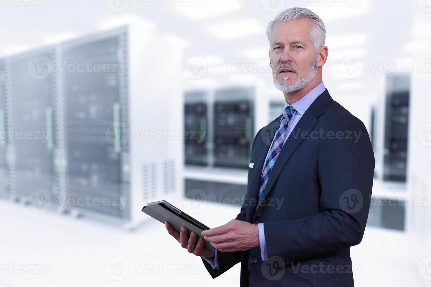 Senior businessman in server room photo