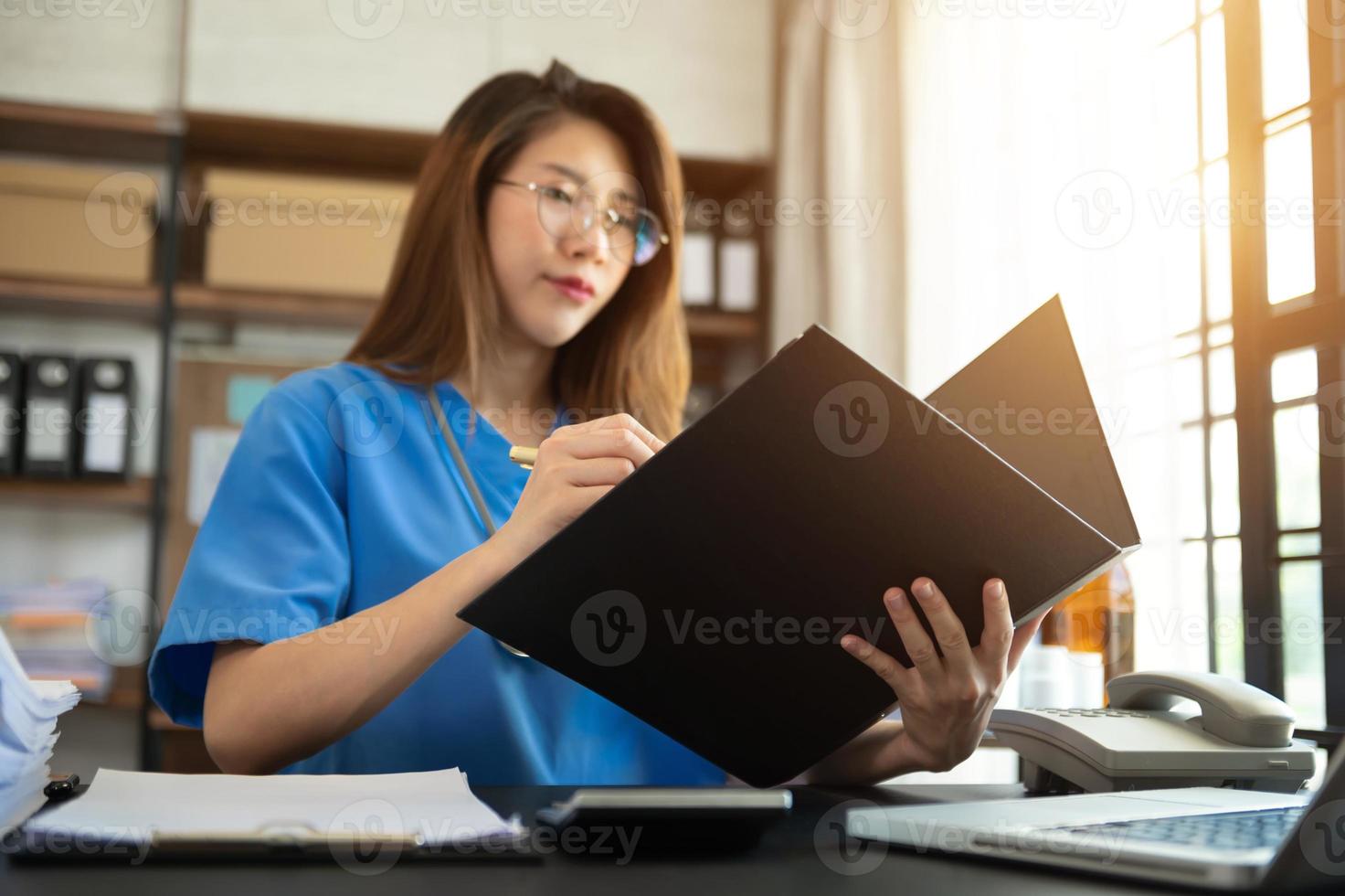 Medicine doctor and stethoscope using notepad, and tablet with  medical network connection and growth chart on laptop, background photo