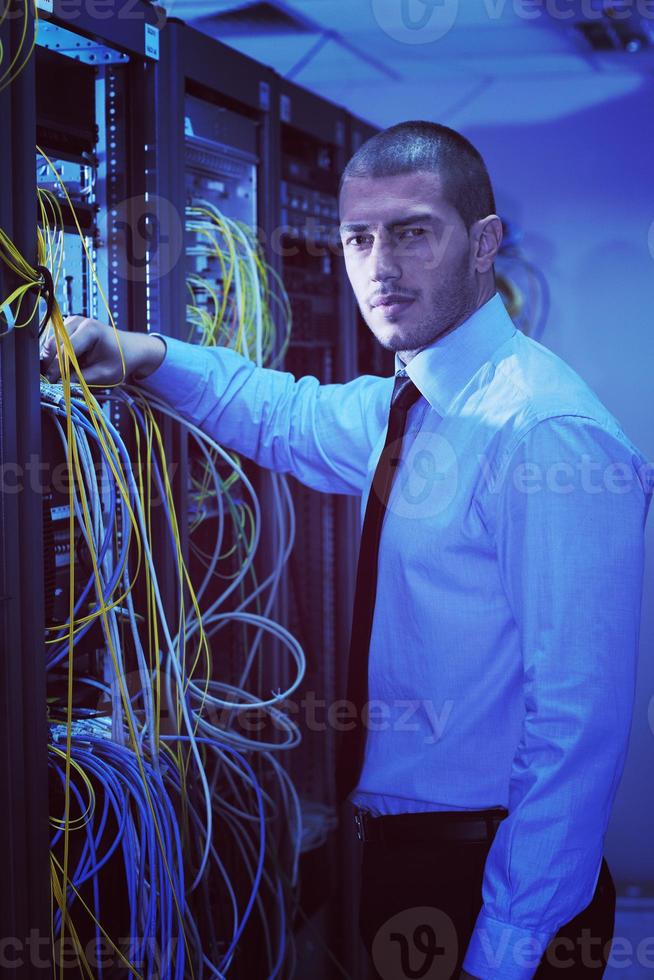 young it engineer in datacenter server room photo