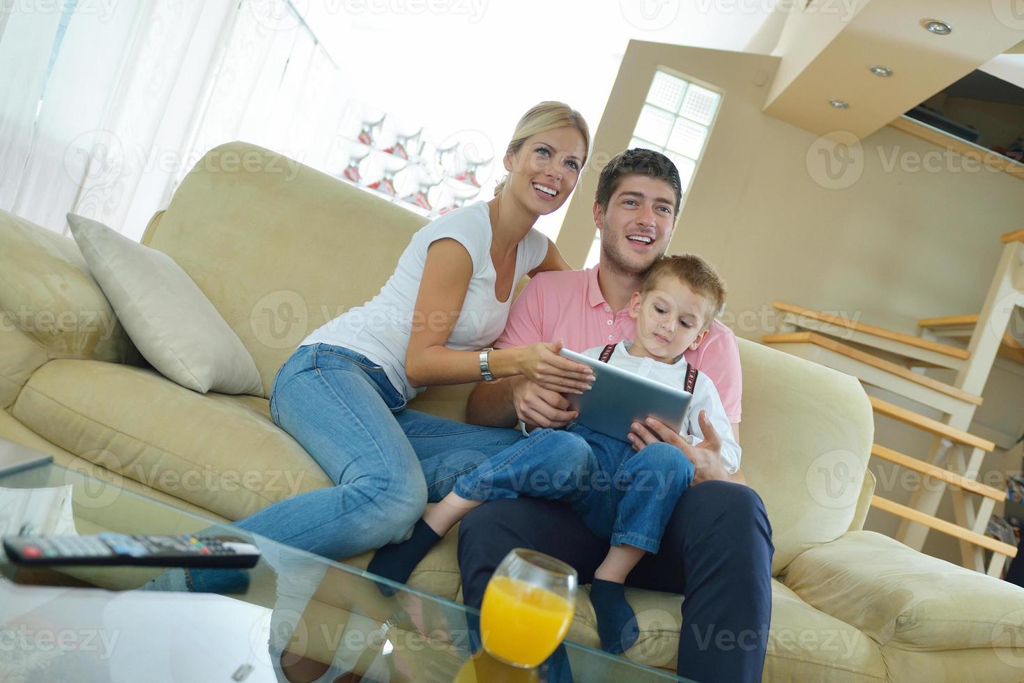 family at home using tablet computer photo