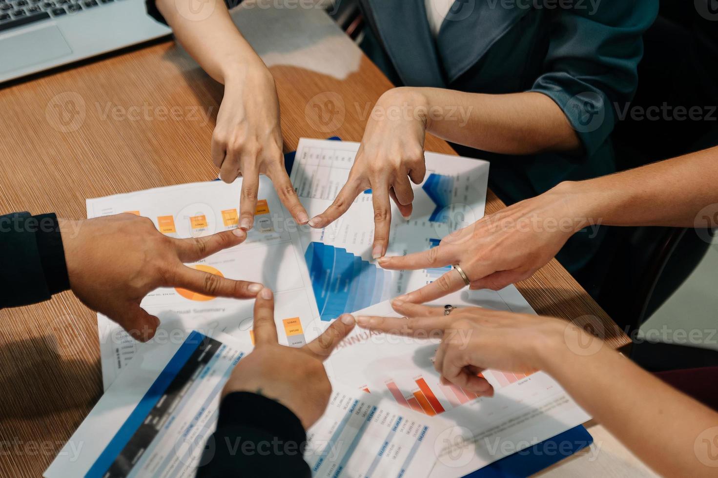 Group of business team workers standing doing symbol with fingers together at the modern office in sun light photo