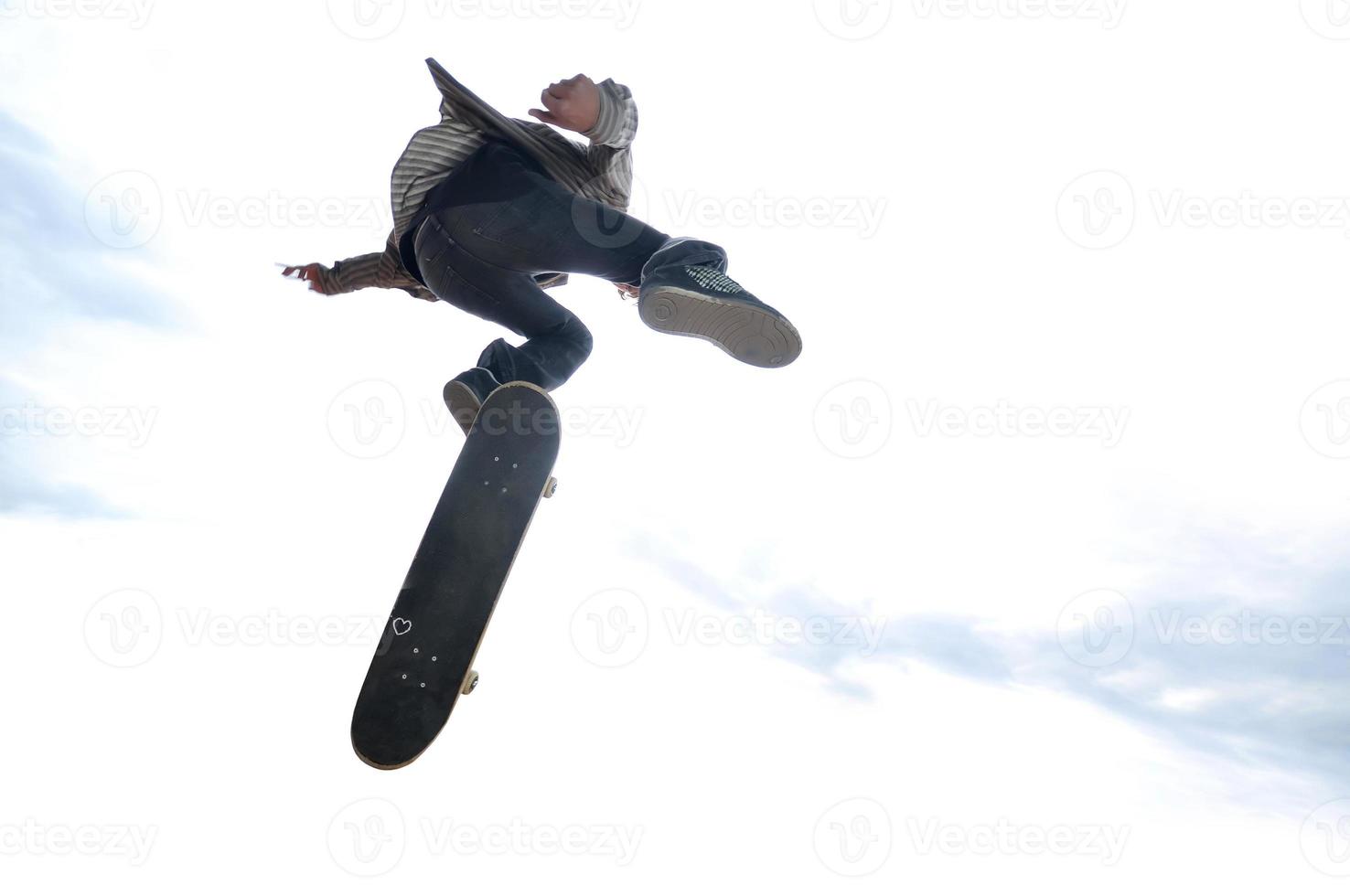 Boy practicing skate in a skate park - isolated photo