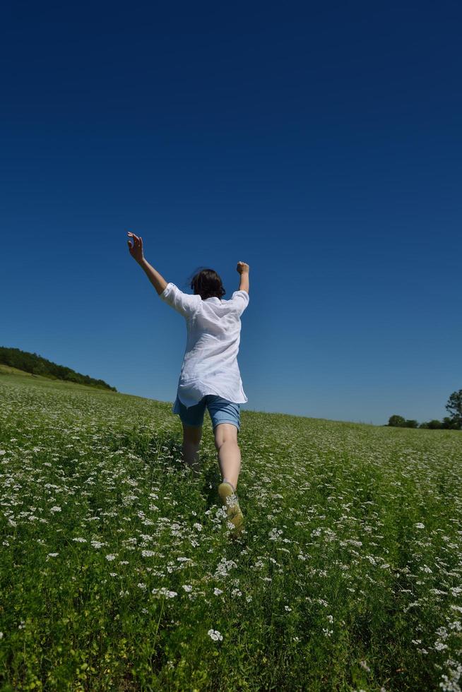 Young happy woman in green field photo