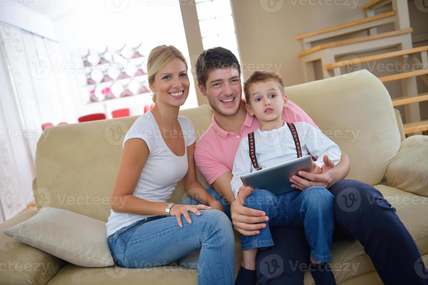 family at home using tablet computer photo