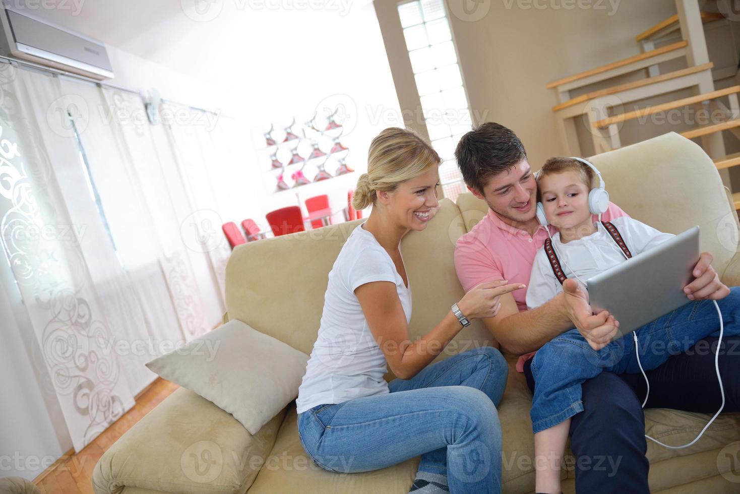 family at home using tablet computer photo
