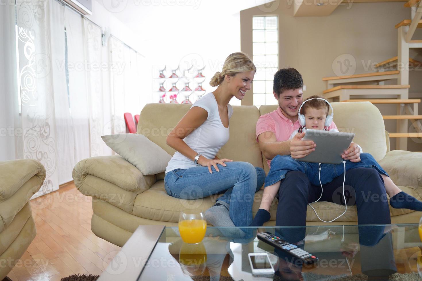 family at home using tablet computer photo