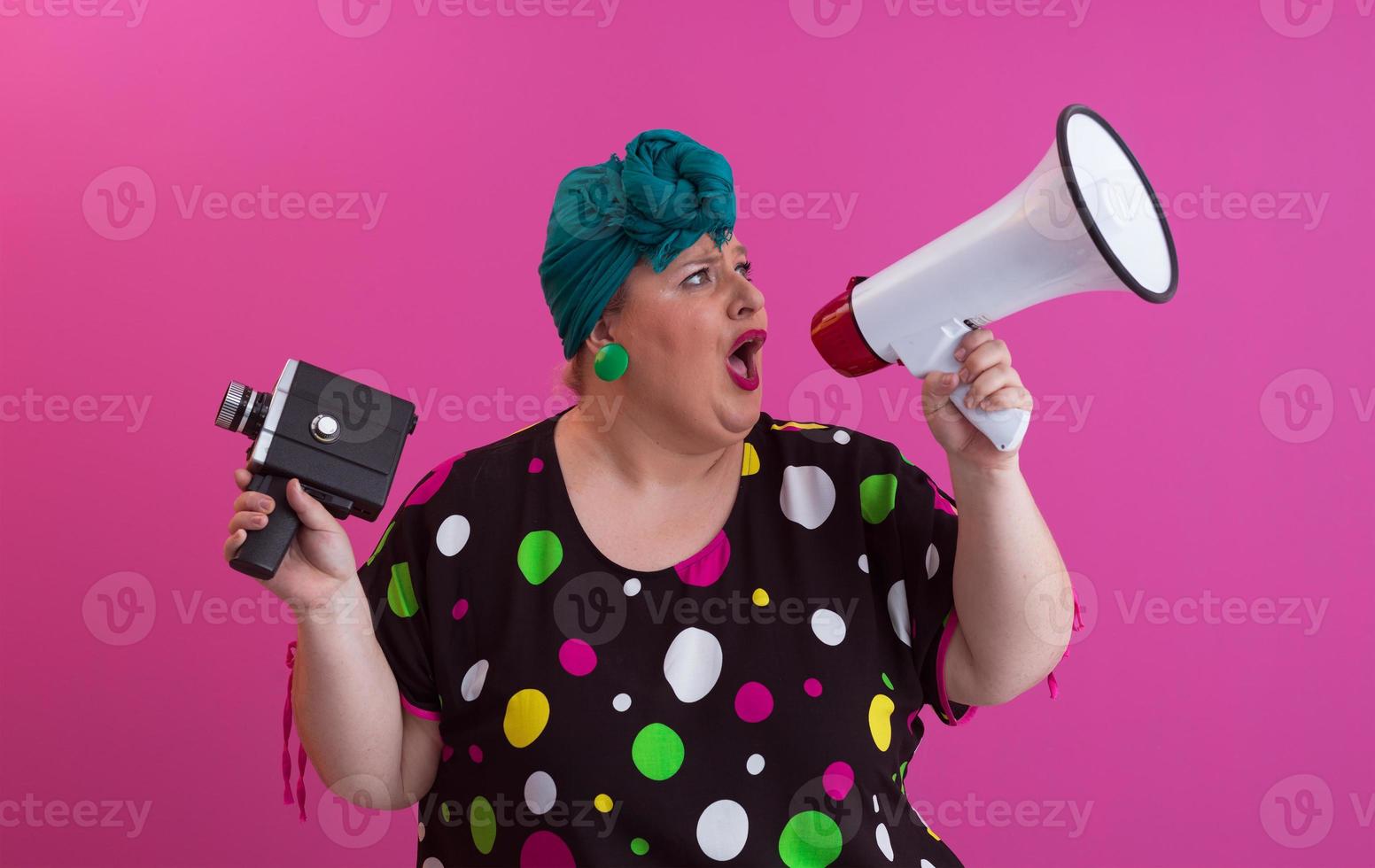 Funny plus size woman woman posing isolated on pink background studio portrait. People emotions lifestyle concept. Mock up copy space. Screaming in megaphone. photo