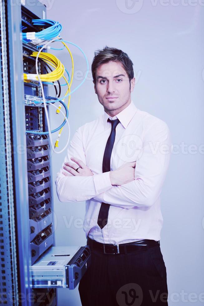 young it engineer in datacenter server room photo