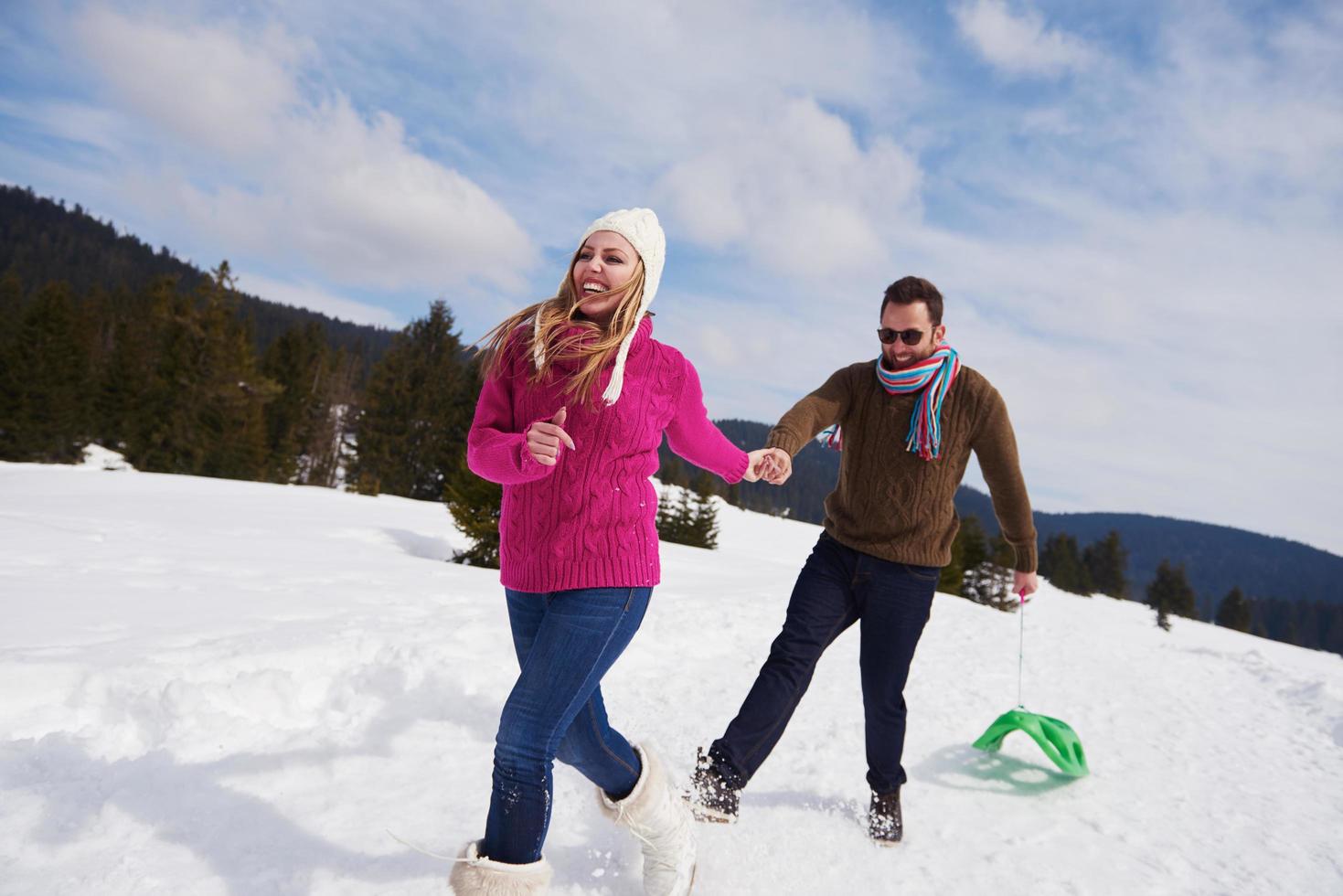 happy young couple having fun on fresh show on winter vacation photo