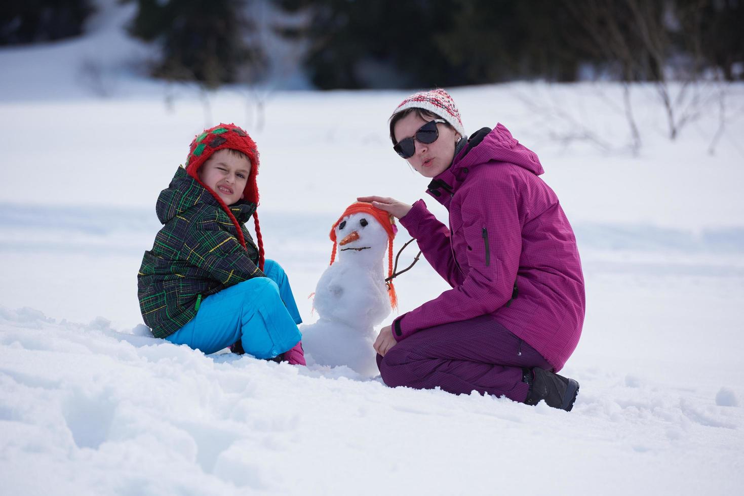 happy family building snowman photo