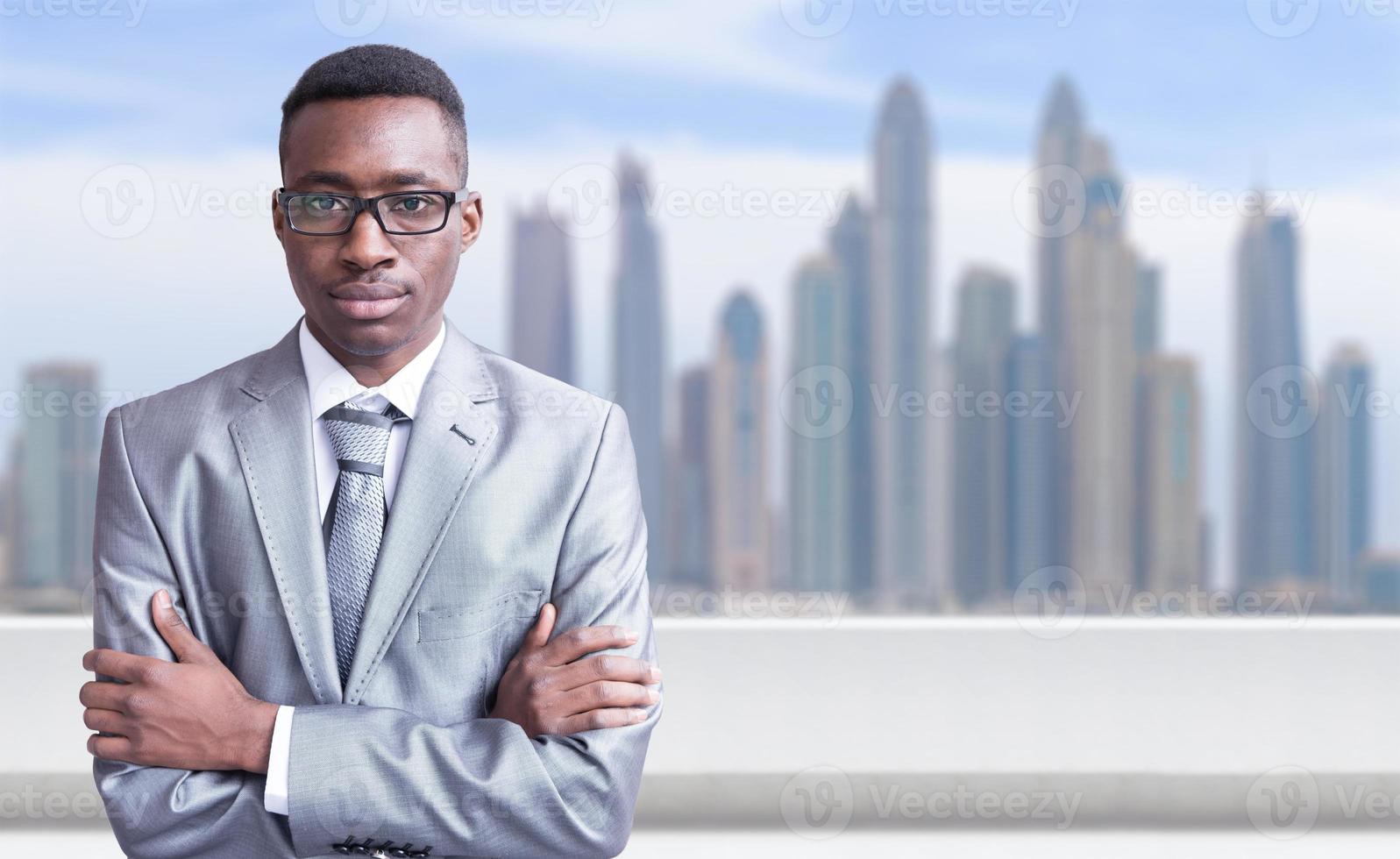 Young black businessman in front of the big city photo