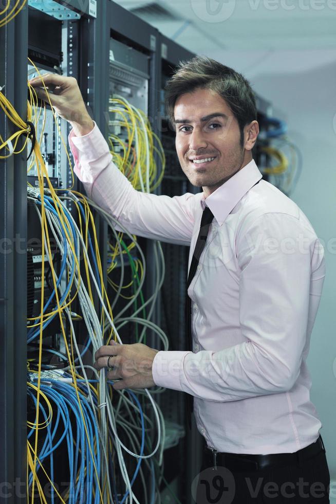 young it engineer in datacenter server room photo