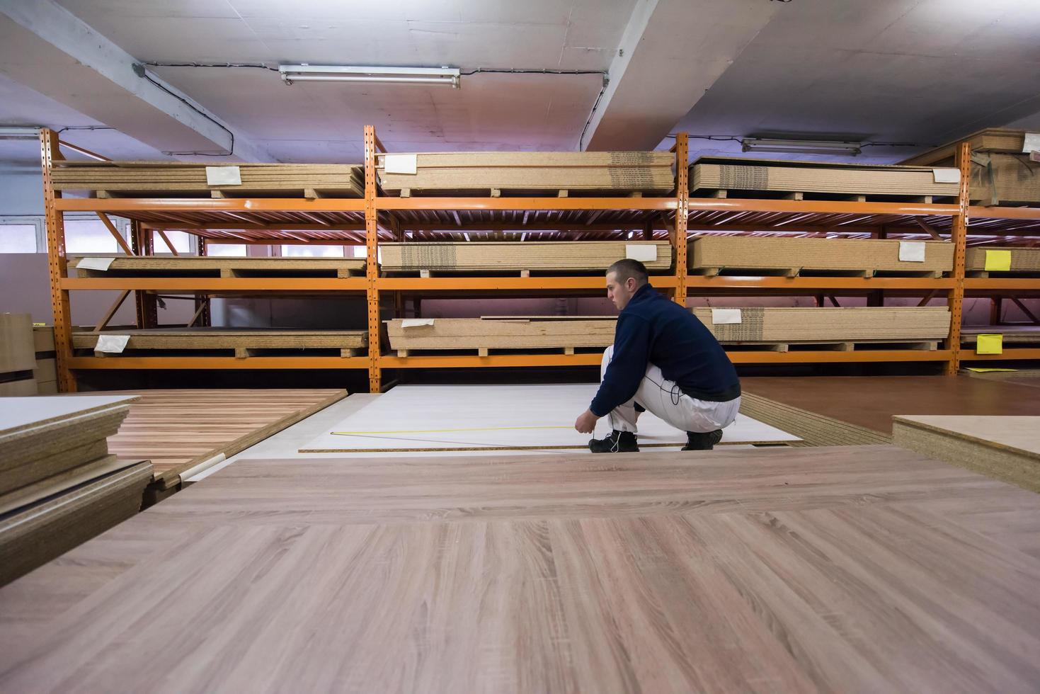 carpenter measuring wooden board photo