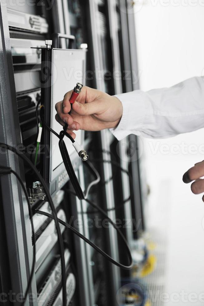 young it engeneer in datacenter server room photo
