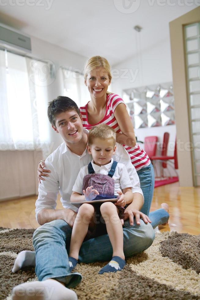 family at home using tablet computer photo