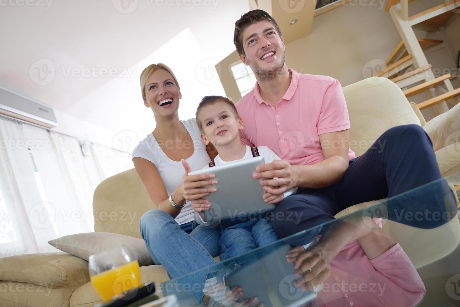 family at home using tablet computer photo