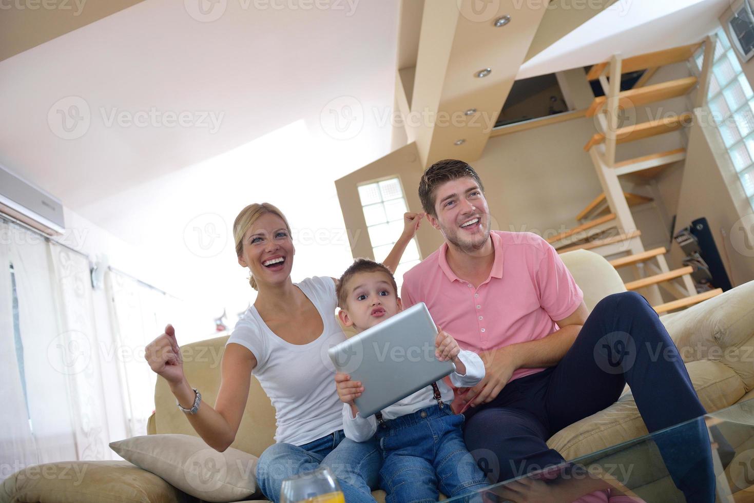 family at home using tablet computer photo