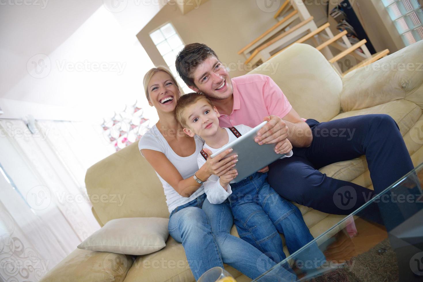 family at home using tablet computer photo
