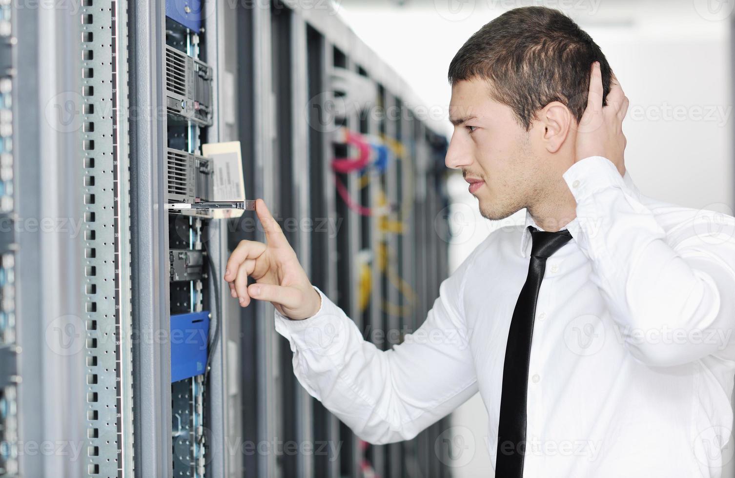 young it engeneer in datacenter server room photo