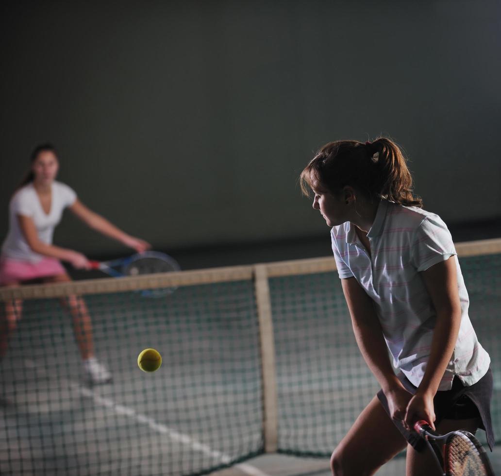 Playing tennis indoors photo